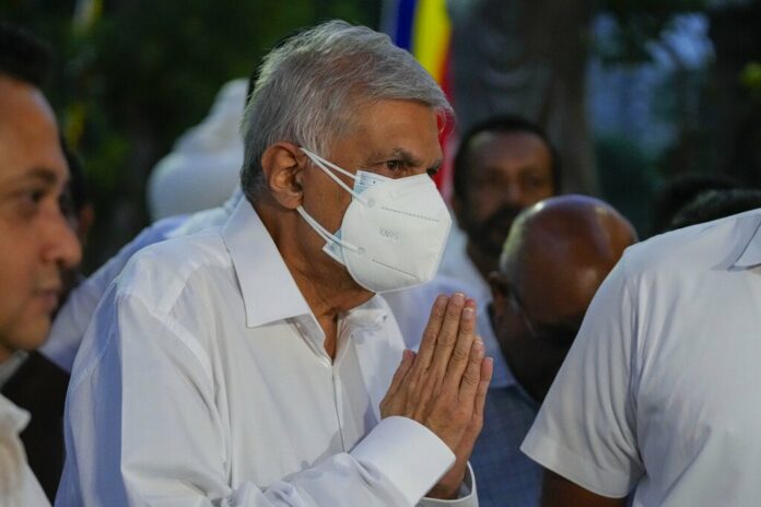 President elect Ranil Wickremesinghe greats supporters upon his arrival at a buddhist temple in Colombo, Sri Lanka, Wednesday, July 20, 2022. Photo: Eranga Jayawardena / AP