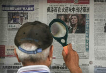 Pelosi Confirms Trip to Asia, but No Mention of Taiwan A man uses a magnifying glass to read a newspaper headline reporting on U.S. House Speaker Nancy Pelosi's Asia visit, at a stand in Beijing, Sunday, July 31, 2022. Photo: Andy Wong / AP