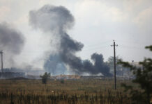 Explosions Rock Crimea in Suspected Ukrainian Attack Smoke rises over the site of explosion at an ammunition storage of Russian army near the village of Mayskoye, Crimea, Tuesday, Aug. 16, 2022. Photo: AP