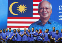 Jailed Najib Fell Mightily From Peak of Malaysian Politics FILE - In this April 7, 2018, file photo, then Malaysia's Prime Minister and President of the ruling party coalition "National Front," Najib Razak, center, prays during launching event for upcoming general elections in Kuala Lumpur, Malaysia. April 7, 2018. Photo: Vincent Thian / AP File