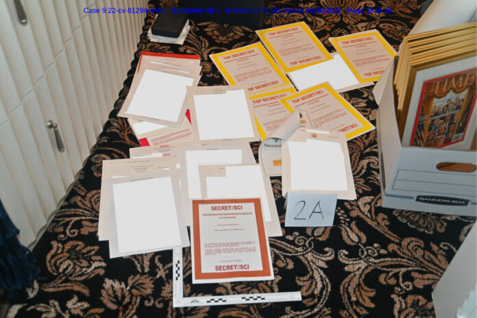 This image contained in a court filing by the Department of Justice on Aug. 30, 2022, and redacted by in part by the FBI, shows a photo of documents seized during the Aug. 8 search by the FBI of former President Donald Trump's Mar-a-Lago estate in Florida. Photo: U.S. Department of Justice via AP