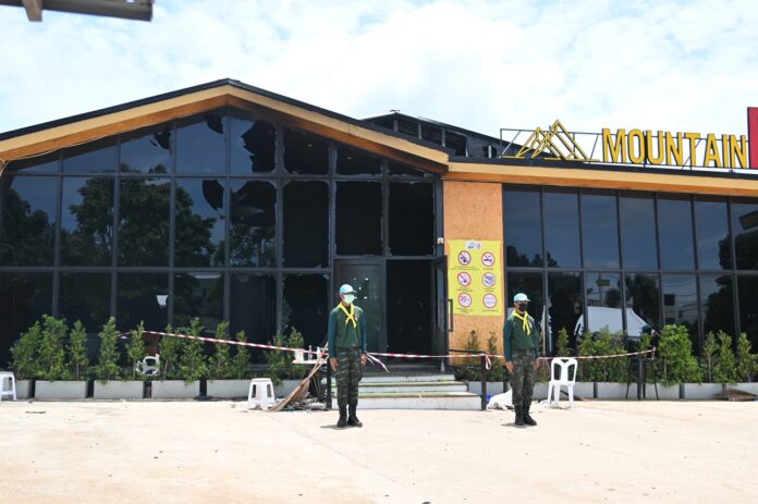 Soldiers stand guard in front of Mountain B pub in the Sattahip district of Chonburi province on Aug. 5, 2022.