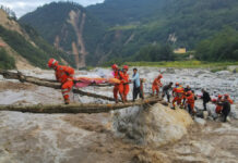 Earthquake Kills 65, Triggers Landslides in Southwest China In this photo released by Xinhua News Agency, rescuers transfer survivors across a river following an earthquake in Moxi Town of Luding County, southwest China's Sichuan Province Monday, Sept. 5, 2022. Photo: Cheng Xueli / Xinhua via AP