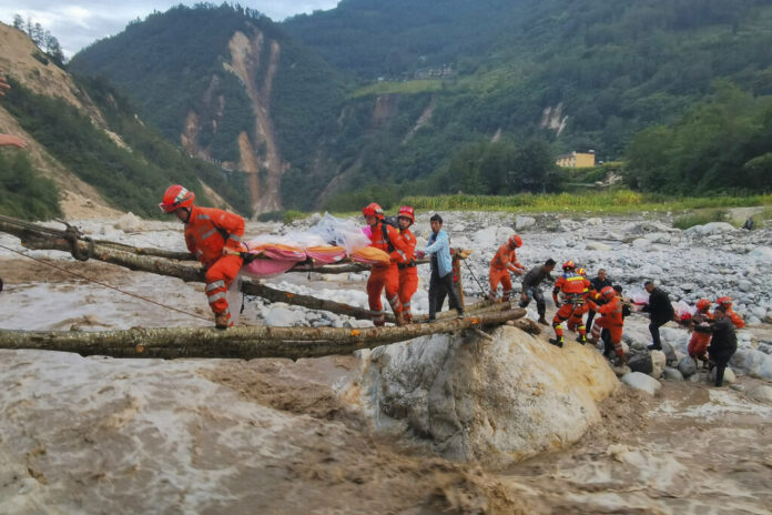 In this photo released by Xinhua News Agency, rescuers transfer survivors across a river following an earthquake in Moxi Town of Luding County, southwest China's Sichuan Province Monday, Sept. 5, 2022. Photo: Cheng Xueli / Xinhua via AP In this photo released by Xinhua News Agency, rescuers transfer survivors across a river following an earthquake in Moxi Town of Luding County, southwest China's Sichuan Province Monday, Sept. 5, 2022. Photo: Cheng Xueli / Xinhua via AP
