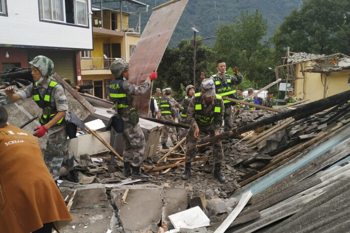 In this photo released by Xinhua News Agency, soldiers clear debris to search for survivors at an earthquake hit Moxi Town of Luding County, southwest China's Sichuan Province Tuesday, Sept. 6, 2022. Photo: Ran Peizong / Xinhua via AP