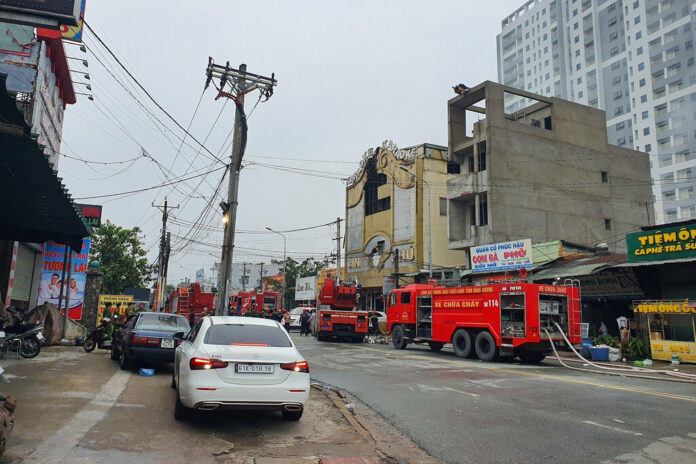 Fire department trucks line outside a karaoke parlor following a fire Wednesday, Sept. 7, 2022, in Thuan An city, southern Vietnam. Photo: Duong Trei Tuong / VNA via AP