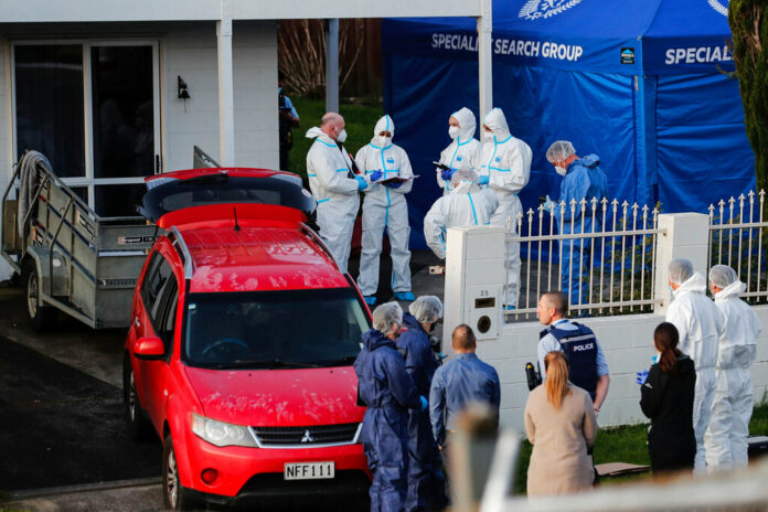 FILE - New Zealand police investigators work at a scene in Auckland on Aug. 11, 2022, after bodies were discovered in suitcases. Photo: Dean Purcell / New Zealand Herald via AP File