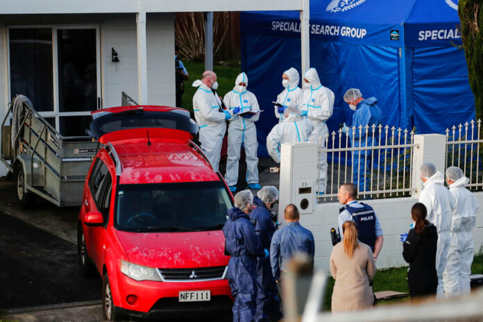 FILE - New Zealand police investigators work at a scene in Auckland on Aug. 11, 2022, after bodies were discovered in suitcases. Photo: Dean Purcell / New Zealand Herald via AP File FILE - New Zealand police investigators work at a scene in Auckland on Aug. 11, 2022, after bodies were discovered in suitcases. Photo: Dean Purcell / New Zealand Herald via AP File