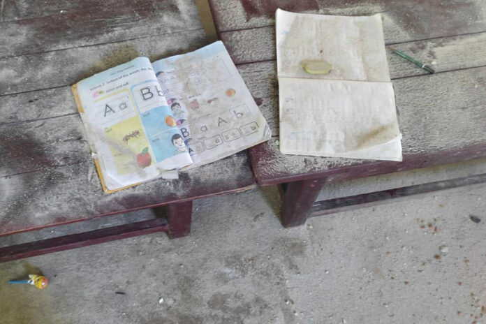 An alphabet book and a notebook lie on top of an elevated wooden floorboard of a middle school in Let Yet Kone village in Tabayin township in the Sagaing region of Myanmar on Saturday, Sept. 17, 2022, the day after an air strike hit the school. Photo: AP An alphabet book and a notebook lie on top of an elevated wooden floorboard of a middle school in Let Yet Kone village in Tabayin township in the Sagaing region of Myanmar on Saturday, Sept. 17, 2022, the day after an air strike hit the school. Photo: AP