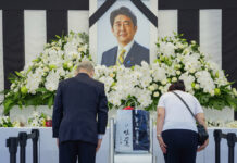 Tense Japan Holds Funeral for Assassinated Ex-leader Abe People leave flowers and pay their respects to former Japanese Prime Minister Shinzo Abe outside the Nippon Budokan in Tokyo Tuesday, Sept. 27, 2022, ahead of his state funeral later in the day. Photo: Nicolas Datiche / Pool Photo via AP
