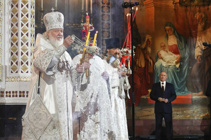 FILE - In this photo released by Russian Orthodox Church Press Service, Russian Orthodox Church Patriarch Kirill, left, conducts the Easter service accompanied by President Vladimir Putin, background right, at the Christ the Savior Cathedral in Moscow, Russia, early Sunday, April 24, 2022. Photo: Oleg Varov / Russian Orthodox Church Press Service via AP