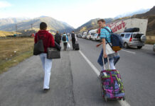 Moscow Tries to Draft Fleeing Russian Men at the Borders People walk toward the border crossing at Verkhny Lars between Georgia, bottom, and Russia leaving Chmi, North Ossetia–Alania Republic, Russia, Wednesday, Sept. 28, 2022. Photo: AP
