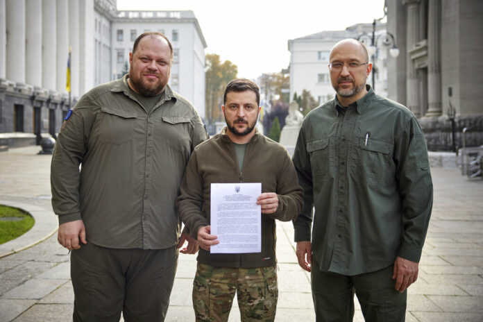 In this photo provided by the Ukrainian Presidential Press Office, Ukrainian President Volodymyr Zelenskyy, center, alongside Prime Minister Denys Shmyhal, right, and the head of Verkhovna Rada (Supreme Council of Ukraine) Ruslan Stefanchuk, holds an application for ''accelerated accession to NATO'' in Kyiv, Ukraine, Friday Sept. 30, 2022. Photo: Ukrainian Presidential Press Office via AP