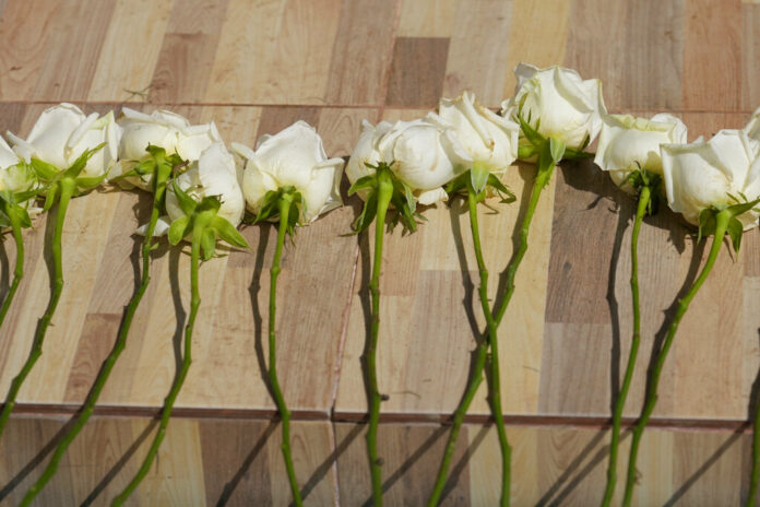 Relatives and friends leave flowers during a ceremony for those killed in the attack on the Young Children's Development Center in the rural town of Uthai Sawan, north eastern Thailand, Friday, Oct. 7, 2022. Photo: Sakchai Lalit / AP