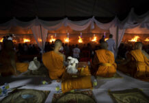 Families Bid Farewell as Nong Bua Lamphu Massacre Victims Are Cremated Monks sit and watch at funeral pyres set to cremate those who died in the day care center attack at Wat Rat Samakee temple in Uthai Sawan, northeastern Thailand, Tuesday, Oct. 11, 2022. Photo: Wason Wanichakorn / AP