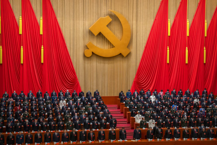 Delegates stand for a moment of silence during the opening ceremony of the 20th National Congress of China's ruling Communist Party at the Great Hall of the People in Beijing, China, Sunday, Oct. 16, 2022. Photo: Mark Schiefelbein / AP