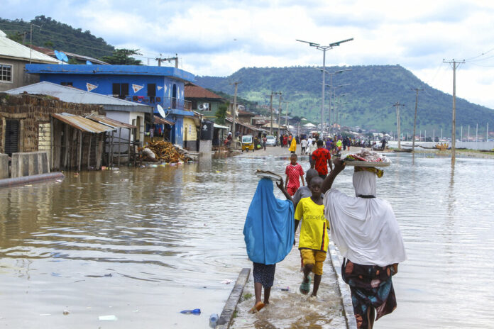 FILE- A view of stranded people due to floods following several days of downpours in Kogi Nigeria, Thursday, Oct. 6, 2022. Photo: Fatai Campbell / AP File