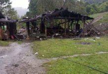 Ethnic Group Says Myanmar Air Attack Kills 80 at Celebration Debris are scattered around destroyed wooden structures near Aung Bar Lay Village, Hpakant township, Kachin state in Myanmar Monday, Oct. 24, 2022. Photo: AP