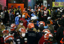 Crush Kills at Least 151 at Halloween Festivities in Seoul Rescue workers try to carry victims on the street near the scene, in Seoul, South Korea, Sunday, Oct. 30, 2022. Photo: Lee Jin-man / AP
