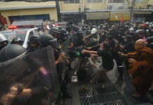 Protesters clash with riot police during a protest on Din Sor Road on Nov. 18, 2022.