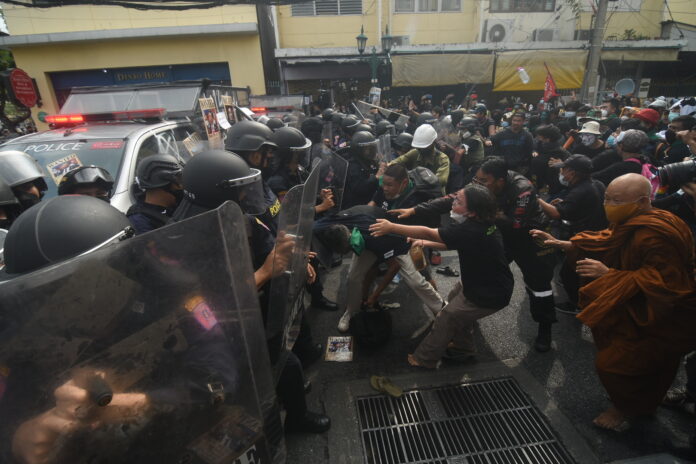 Protesters clash with riot police during a protest on Din Sor Road on Nov. 18, 2022.