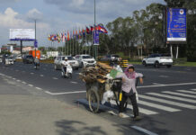 Myanmar Tops ASEAN Summit’s Agenda as Global Issues Loom A recycler pulls her cart past a billboard advertising the upcoming Association of Southeast Asian Nations (ASEAN) summits in Phnom Penh, Cambodia, Tuesday, Nov. 8, 2022. Photo: Heng Sinith / AP