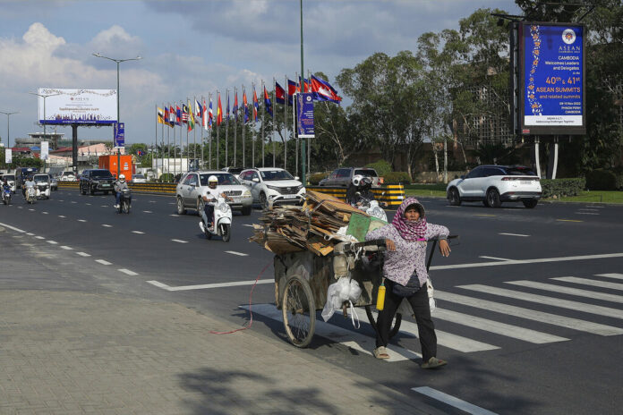 A recycler pulls her cart past a billboard advertising the upcoming Association of Southeast Asian Nations (ASEAN) summits in Phnom Penh, Cambodia, Tuesday, Nov. 8, 2022. Photo: Heng Sinith / AP A recycler pulls her cart past a billboard advertising the upcoming Association of Southeast Asian Nations (ASEAN) summits in Phnom Penh, Cambodia, Tuesday, Nov. 8, 2022. Photo: Heng Sinith / AP