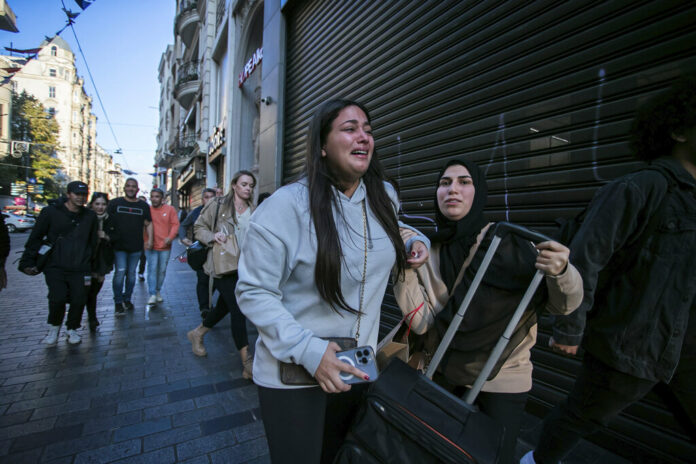 People leave the area after an explosion on Istanbul's popular pedestrian Istiklal Avenue Sunday, Istanbul, Sunday, Nov. 13, 2022. Photo: Can Ozer / AP People leave the area after an explosion on Istanbul's popular pedestrian Istiklal Avenue Sunday, Istanbul, Sunday, Nov. 13, 2022. Photo: Can Ozer / AP