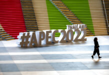 A participant runs past signage at the venue of the Asia-Pacific Economic Cooperation APEC summit venue, Friday, Nov. 18, 2022, in Bangkok, Thailand. Photo: Anupam Nath / AP