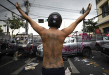 Opinion: Thailand’s ‘Open, Connect, Balance’ APEC 2022? Spare Me the Propaganda A protester raises his arms behind vandalized police vehicles during a confrontation with police as they try to march to the Asia-Pacific Economic Cooperation APEC summit venue, Friday, Nov. 18, 2022, in Bangkok, Thailand. Photo: Wason Wanichakorn / AP