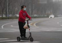 China Expands Lockdowns as COVID-19 Cases Hit Daily Record A resident rides a scooter along a quiet street in a district as restaurants are shut and residents encouraged to stay in their vicinity in Beijing, Thursday, Nov. 24, 2022. Photo: Ng Han Guan / AP