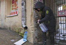Bombed, Not Beaten: Ukraine’s Capital Flips to Survival Mode Kateryna Luchkina, a 31-year-old worker at Kyiv’s Department of Health, collects rainwater from a drainpipe in Kyiv, Ukraine, on Thursday. Nov. 24, 2022. Photo: John Leicester / AP