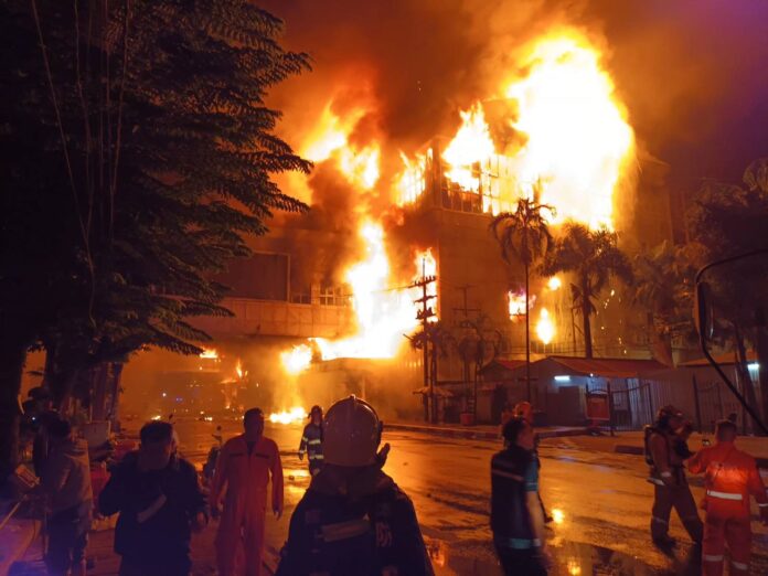 Flames rise from the Grand Diamond City Casino and Hotel in the border town of Poipet, Cambodia on Dec. 29, 2022.