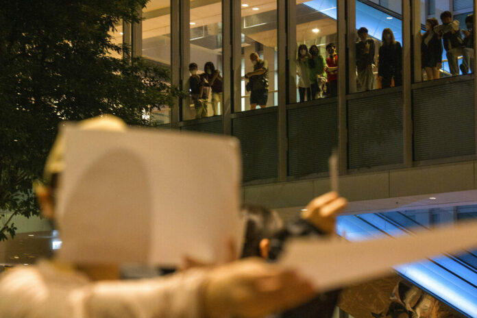 People watch from above at a protest gathering at the University of Hong Kong in Hong Kong, Tuesday, Nov. 29, 2022. Photo: Bertha Wang / AP