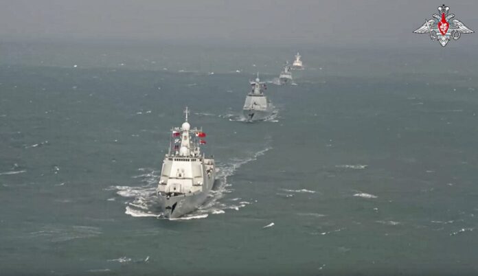 In this handout photo taken from video released by Russian Defense Ministry Press Service on Thursday, Dec. 22, 2022, Chinese warships take part in joint naval drills with Russia in the East China Sea on Thursday. Photo: Russian Defense Ministry Press Service via AP