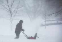 A person clears snow as a winter storm rolls through Western New York Saturday, Dec. 24, 2022, in Amherst N.Y. Photo: Jeffrey T. Barnes / AP