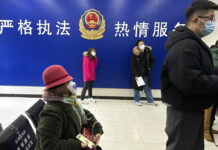 Lack of Info on China’s COVID Outbreak Stirs Global Concerns Residents line up at the community police station for document applications including for passports near the words "Strict law enforcement, enthusiastic service" in Beijing, Wednesday, Dec. 28, 2022. Photo: Ng Han Guan / AP
