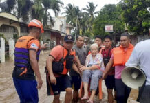 Floods in Philippines Leave 51 Dead, Over a Dozen Missing In this image provided by the Philippine Coast Guard, an elderly woman sits on a chair while being carried by coast guard personnel wading through floodwaters in Plaridel, Misamis Occidental province in the southern Philippines, Monday, Dec. 26, 2022. Photo: Philippine Coast Guard via AP