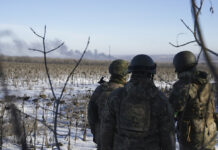 Battle Rages in Ukraine Town; Russia Shakes up Its Military Ukrainian soldiers watch as smoke billows during fighting between Ukrainian and Russian forces in Soledar, Donetsk region, Ukraine, Wednesday, Jan. 11, 2023. Photo: Libkos / AP