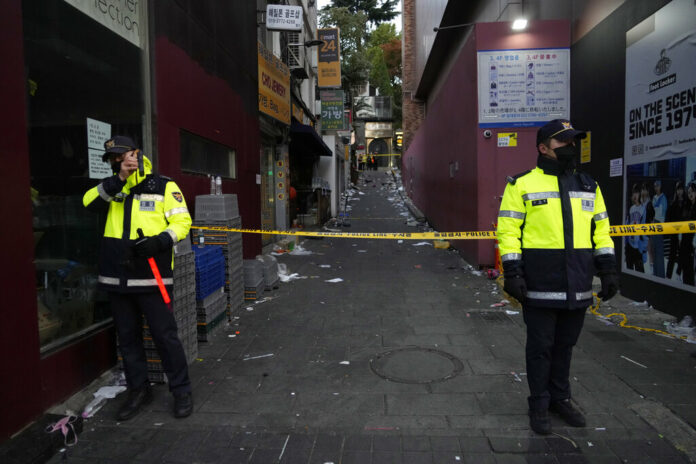 FILE- Police officers stand guard at the scene where dozens of people died and were injured during a crowd surge in Seoul, South Korea, on Oct. 30, 2022. Photo: Ahn Young-joon / AP File