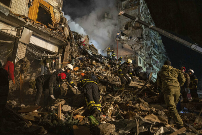 Emergency workers clear the rubble after a Russian rocket hit a multistory building leaving many people under debris in the southeastern city of Dnipro, Ukraine, Saturday, Jan. 14, 2023. Photo: Evgeniy Maloletka / AP Emergency workers clear the rubble after a Russian rocket hit a multistory building leaving many people under debris in the southeastern city of Dnipro, Ukraine, Saturday, Jan. 14, 2023. Photo: Evgeniy Maloletka / AP