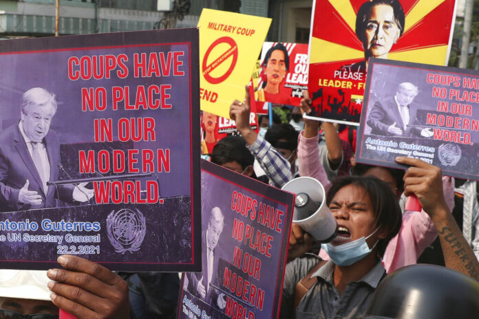FILE - Anti-coup protesters hold up signs as they march in Mandalay, Myanmar Sunday, March 14, 2021. Photo: AP FIle FILE - Anti-coup protesters hold up signs as they march in Mandalay, Myanmar Sunday, March 14, 2021. Photo: AP FIle