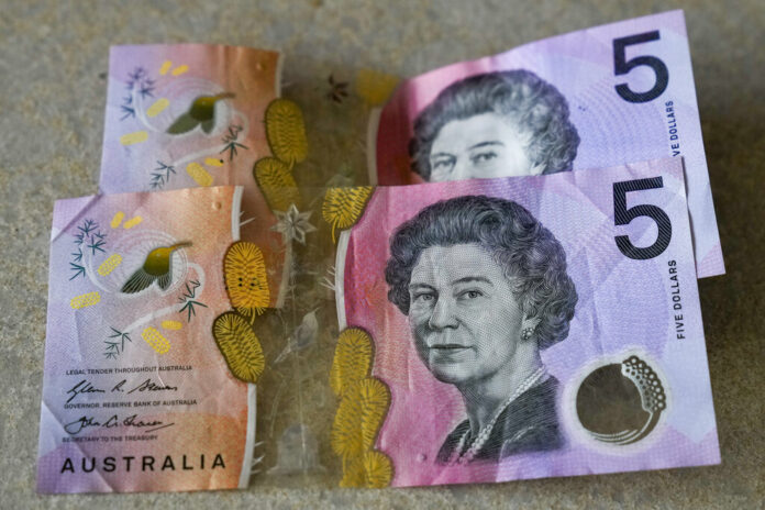 FILE - Australian $5 notes are pictured in Sydney on Sept. 10, 2022. King Charles III won’t feature on Australia's new $5 bill, the nation's central bank announced Thursday, Feb. 2, 2023, signaling a phasing out of the British monarchy from Australian bank notes, although he is still expected to feature on coins. Photo: Mark Baker / AP File