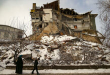 Crews Find Survivors, Many Dead After Turkey, Syria Quake People walk past a collapsed building in Malatya, Turkey, Tuesday, Feb. 7, 2023. Photo: Emrah Gurel / AP