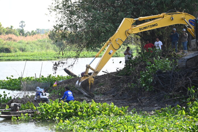 Rescue workers use an excavator to search for the remains of a 8-month-old baby in Nakhon Pathom province on Feb. 27, 2023.