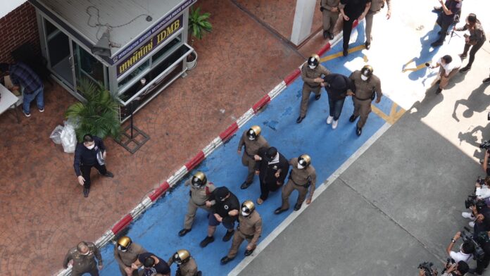 Police escort fellow officers who are involved in the alleged extortion of Taiwanese actress Charlene An, while leaving the Metropolitan Police Bureau on Feb. 2, 2023.