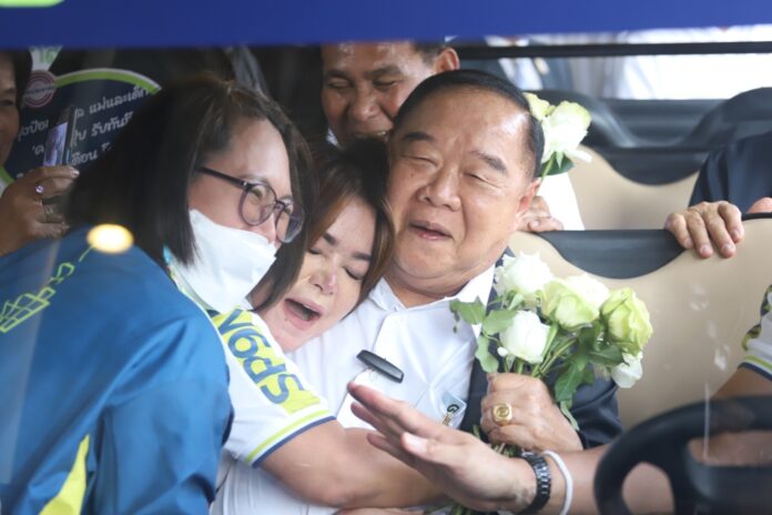 A supporter hugs deputy PM Gen. Prawit Wongsuwan, who is also the leader of the ruling Phalang Pracharath Party, during a visit to Samut Prakarn province on Mar. 3, 2023.