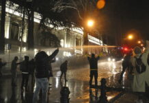 Georgians Protest Against Draft Law on Media, Nonprofits The police fire water cannon at protesters outside the Georgian parliament building in Tbilisi, Georgia, Tuesday, March 7, 2023. Photo: Nicolo Vincenzo Malvestuto / AP