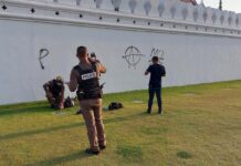 Opinion: Another Episode of Thailand a Society in Denial Police arrest a man who graffiti the wall of the Grand Palace complex on Mar. 28, 2023.
