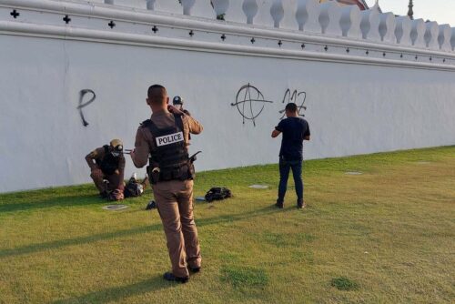 Police arrest a man who graffiti the wall of the Grand Palace complex on Mar. 28, 2023.